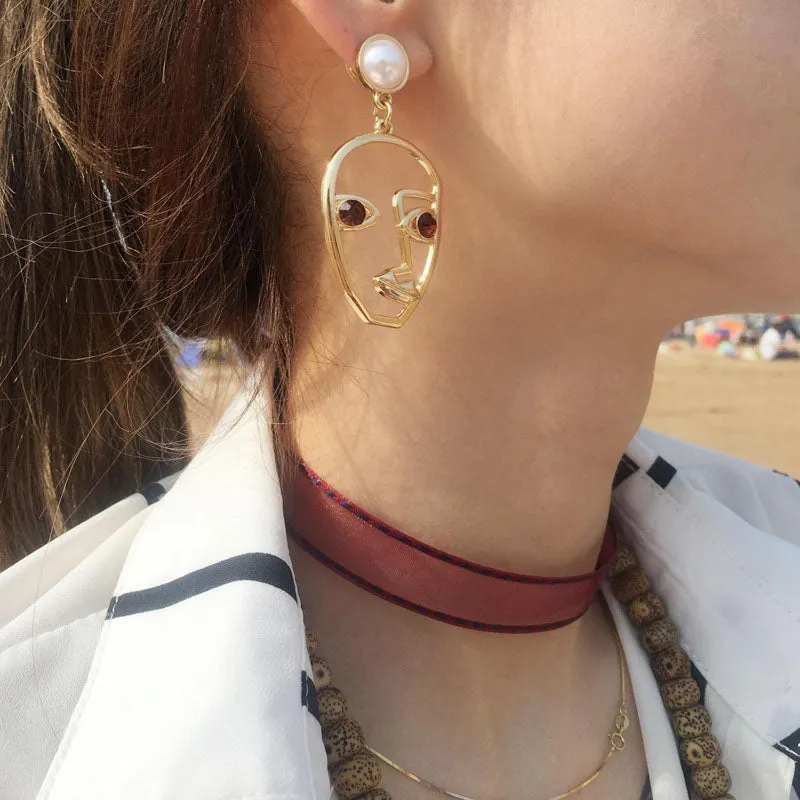 abstract hollow face drop earrings